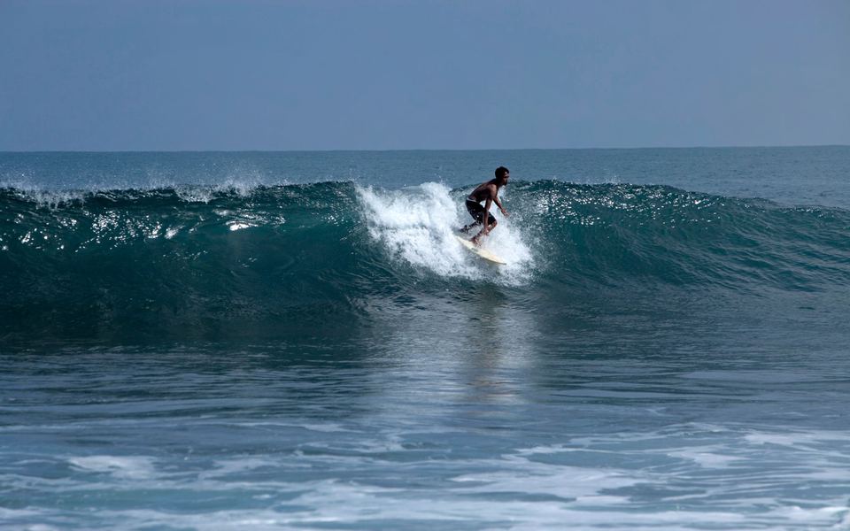 A surfer on a right at Montañita, Ecuador.